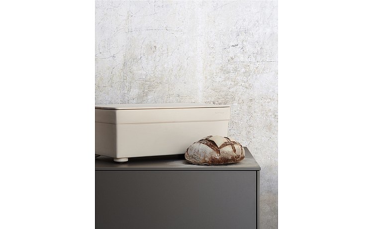 Bread container made from light stoneware with natural maple grain wooden lid, which serves as a bread cutting board