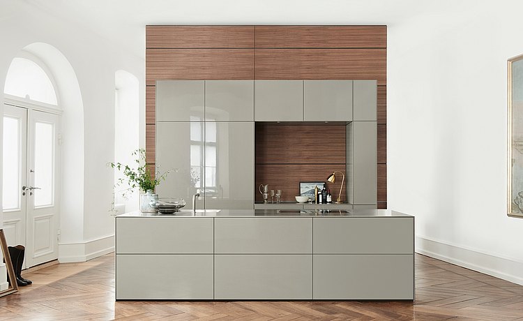 b3 with cabinets and island with gray lacquer front panels in front of the functional wall made from dark veneer
