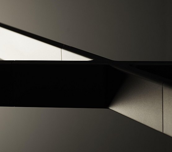 The aluminum cross brings stability and structure as a form-giving centerpiece