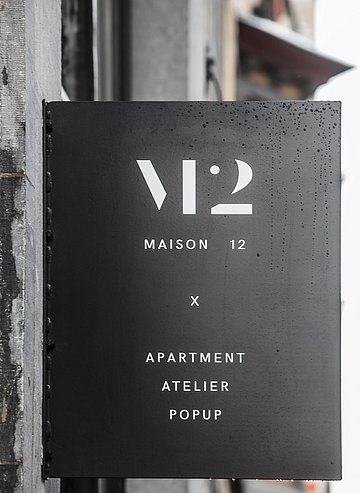 Het uithangbord van Maison12 in de Gentse Onderstraat.